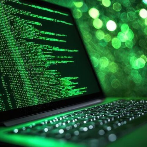 laptop-with-green-screen-code-dark-background_1222783-29249